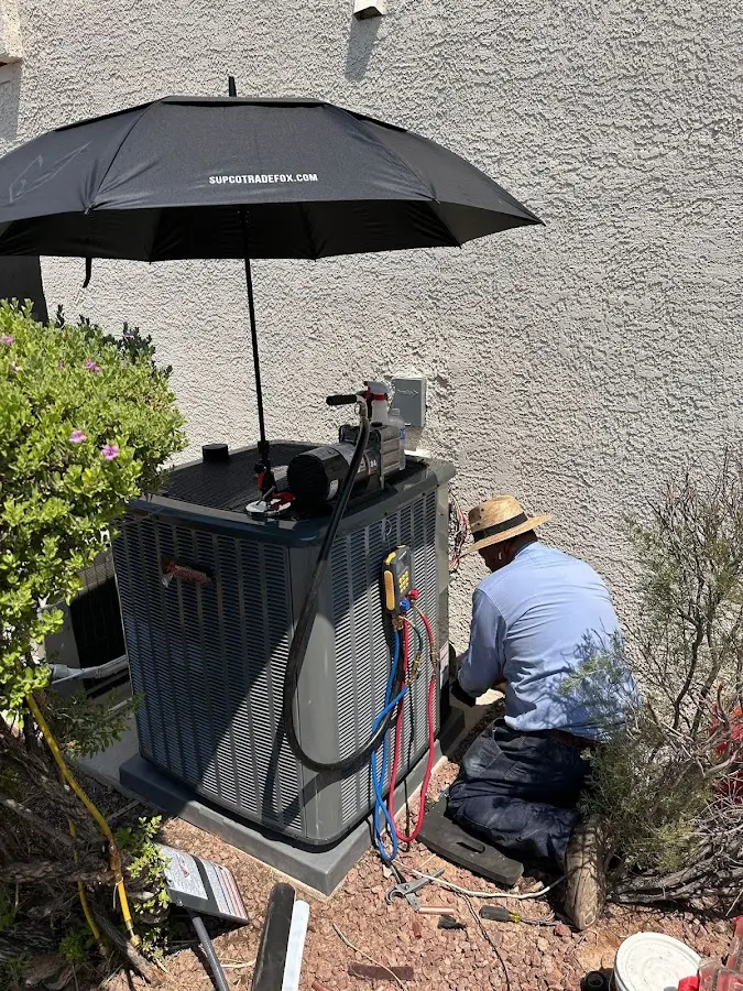 HVAC technician performing outdoor AC maintenance in Solvang